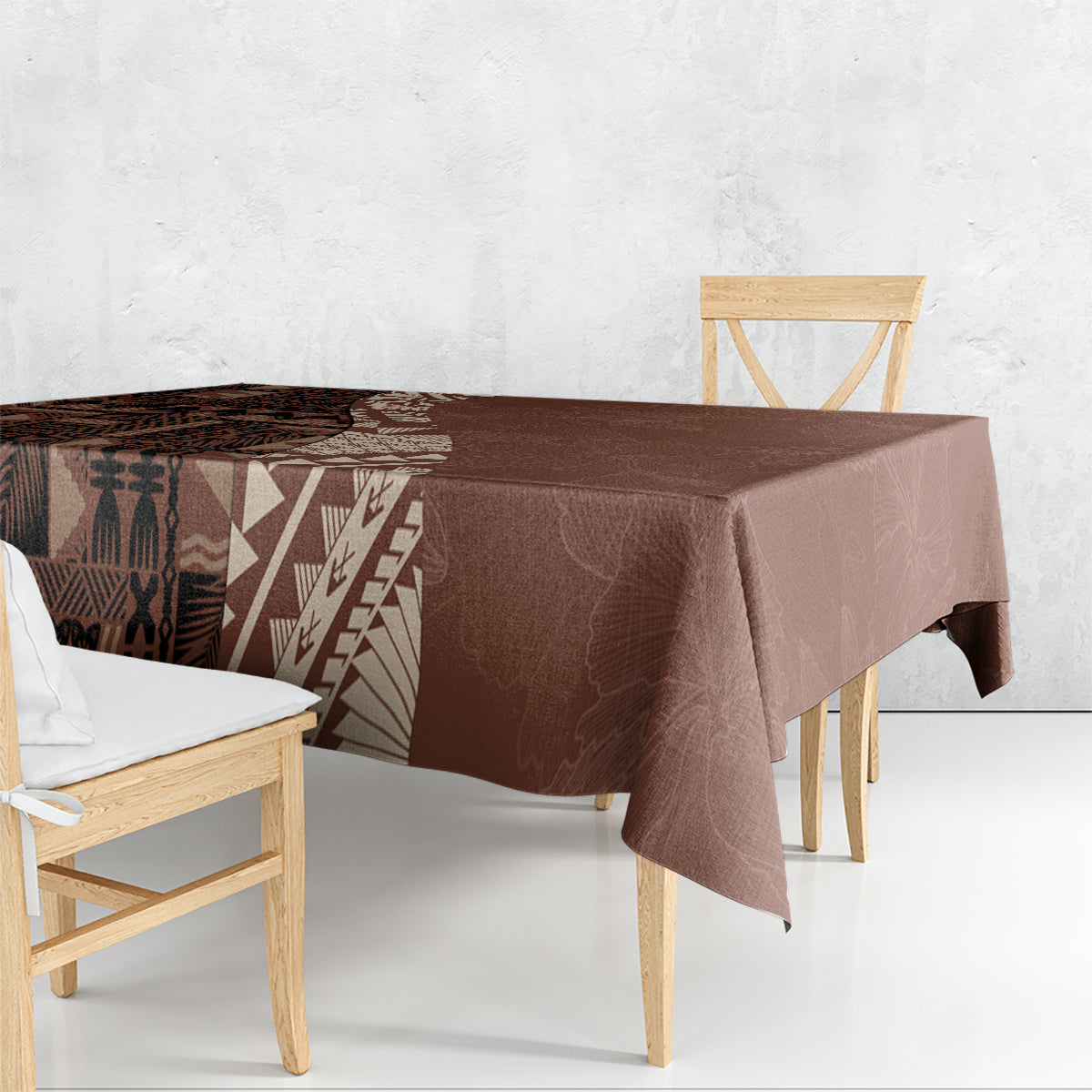 Brown tablecloth draped on dining table with geometric tribal panel and printed edge