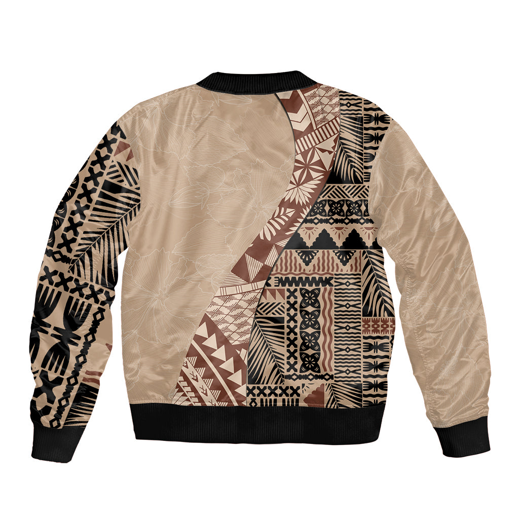 Beige bomber jacket with black ribbed cuffs, back view, tribal patchwork panel design