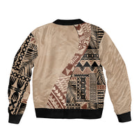 Beige bomber jacket with black ribbed cuffs, back view, tribal patchwork panel design