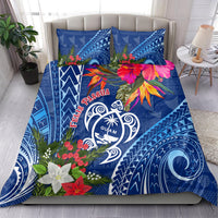 Blue bedding set with Guam turtle emblem, colorful flowers, and matching pillow covers