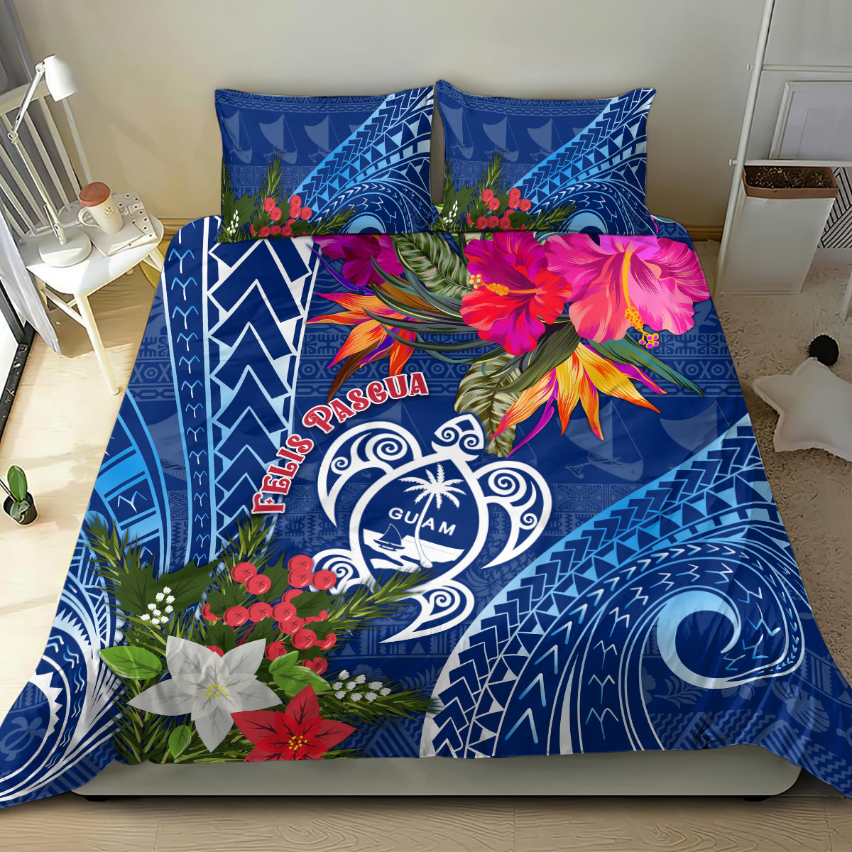 Blue bedding set on bed with Guam turtle emblem, poinsettia flowers, and tapa-style designs