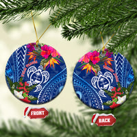 Blue round ceramic turtle Christmas ornament with floral design and gold hanging loop
