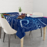 Blue Christmas tablecloth with turtle emblem and geometric tapa motifs on table