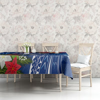 Blue Christmas tablecloth with turtle and poinsettia accents over dining table