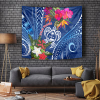 Blue Guam turtle emblem tapestry with red Pasqua text, flowers, and tribal patterns.