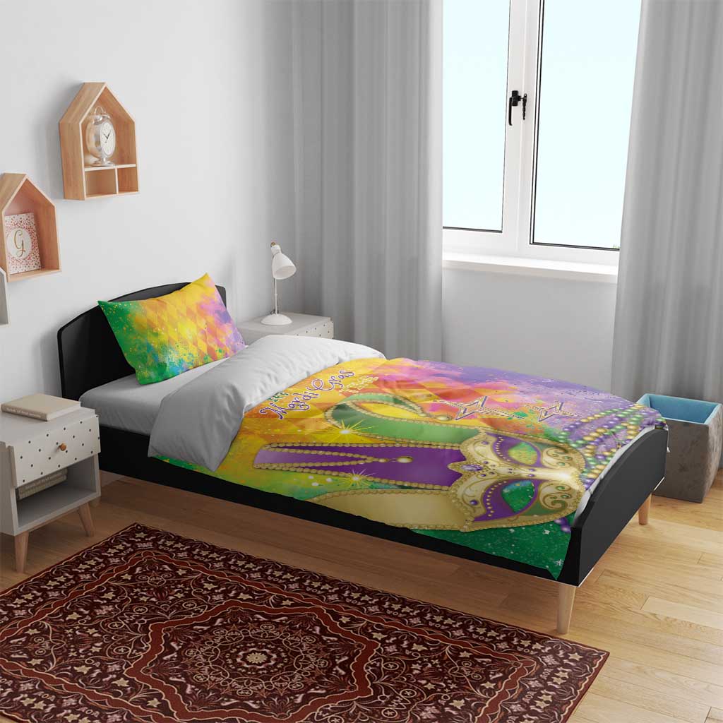 Colorful Mardi Gras bedding set on bed with watercolor mask and stars; two decorative pillows