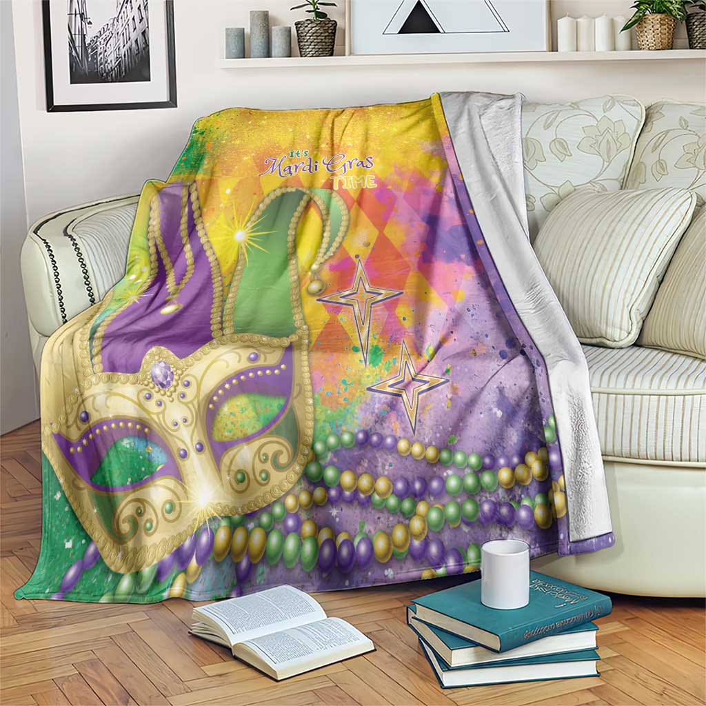 Colorful watercolor Mardi Gras blanket with gold masquerade mask, beads, and star icons