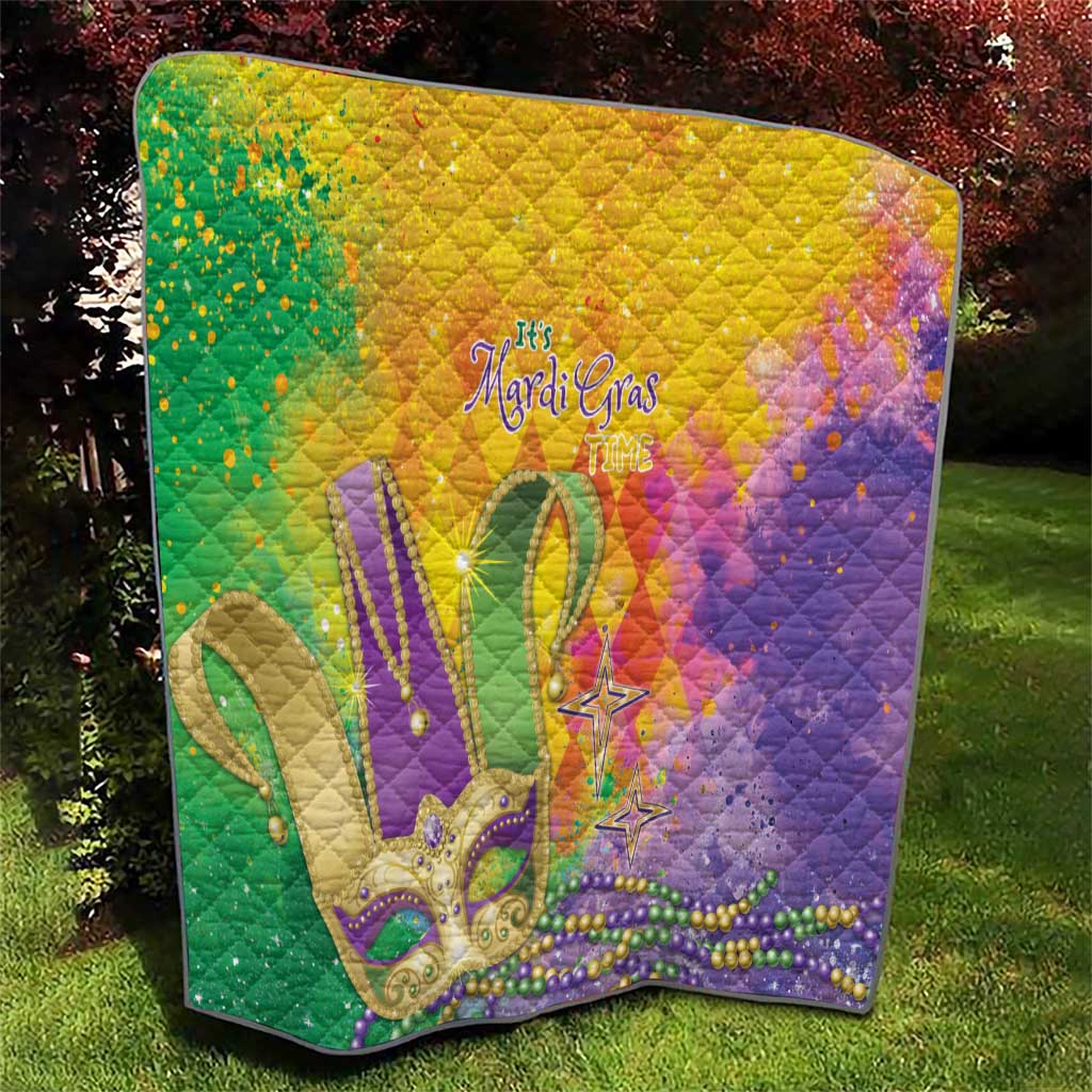 Multicolor quilt with Mardi Gras fleur-de-lis, stars, and bead trim; quilted diamond texture