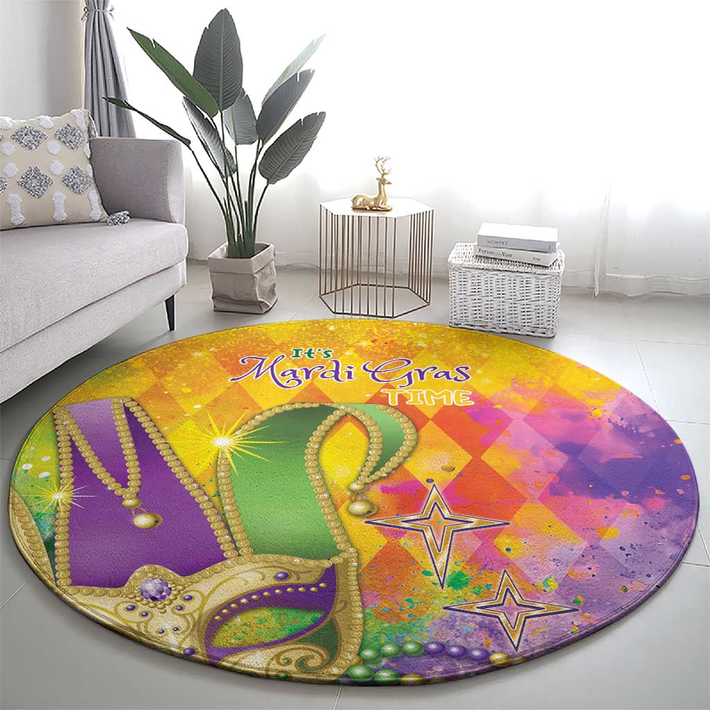 Round Mardi Gras watercolor rug with ornate green crown, beads, and star accents; text “It’s Mardi Gras”