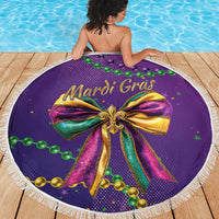 Round purple Mardi Gras beach blanket with tassel fringe, Mardi Gras bow and beaded accents.