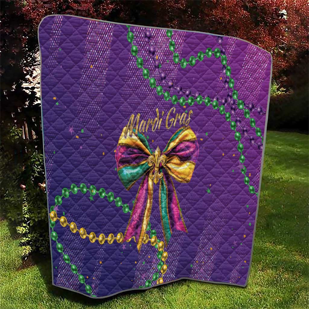 Purple quilted throw with Mardi Gras bow center design and green bead garland details
