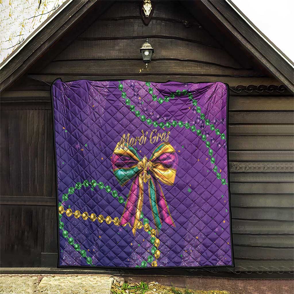 Purple quilted blanket hung on a wooden wall with Mardi Gras bow and green beads