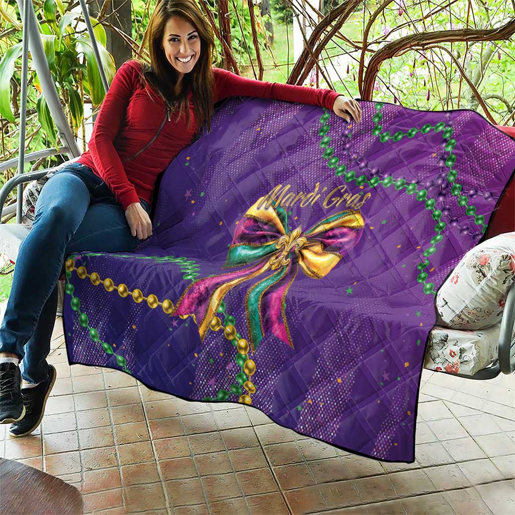Purple quilted throw blanket with Mardi Gras bow motif and green bead strand accents