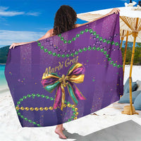 Purple glitter Mardi Gras sarong with bow and bead motifs, draped over model