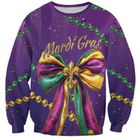 Purple sweatshirt with glitter Mardi Gras bow graphic, green and gold beaded accents