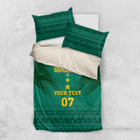 Green and white bedding set layout: duvet with Cameroon crest, 'YOUR TEXT' and '07'