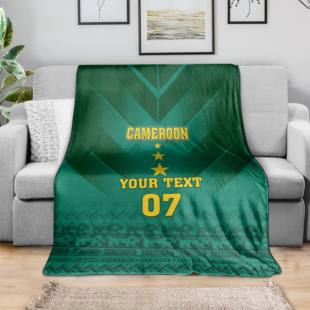 Green Cameroon football blanket on sofa with “CAMEROON”, stars, “YOUR TEXT”, “07”