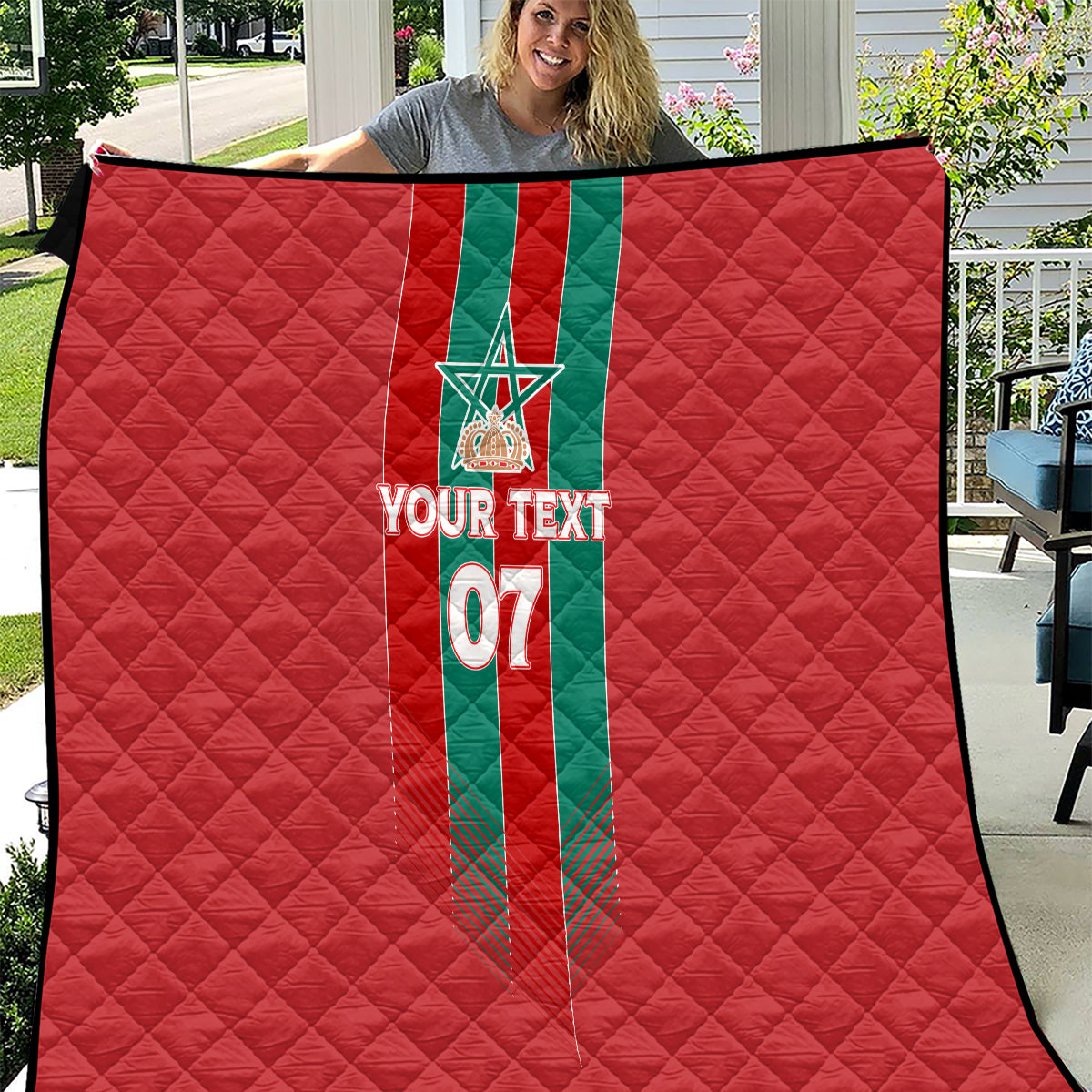 Custom red quilt with green vertical Moroccan stripe, emblem, and 'YOUR TEXT 07' design.