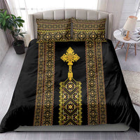 Black bedding set with gold-and-green vertical border pattern and central cross medallion