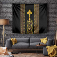 Black tapestry with gold Ethiopian-style vertical motifs and central cross design.