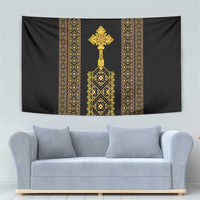 Black hanging tapestry with gold vertical ornamental bands and central emblem cross.