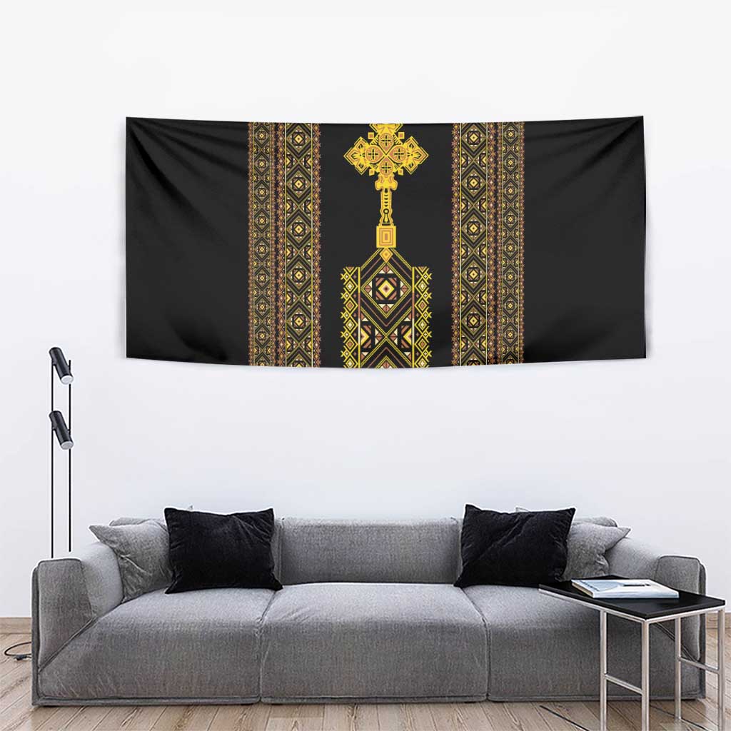 Black wall tapestry with gold Ethiopian-inspired center cross and geometric pattern.