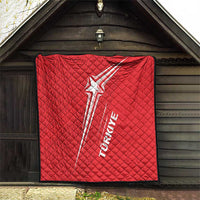Red quilt with white star-and-stripe Turkey graphic and quilted diamond stitching