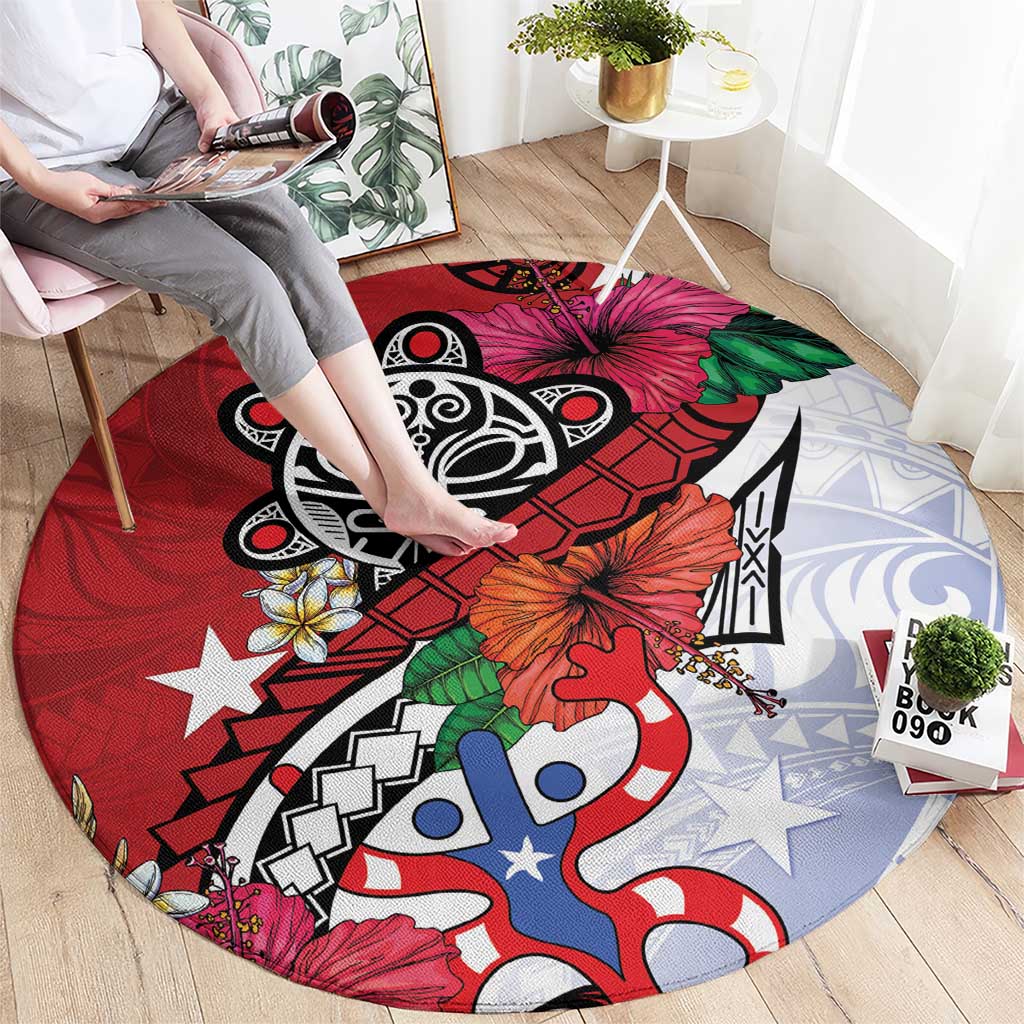 Red round rug with black tribal graphic, blue-and-white figures, and orange flower accents.