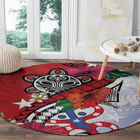 Red round rug with black emblem and blue-and-white waves, plus tropical leaves and flowers.