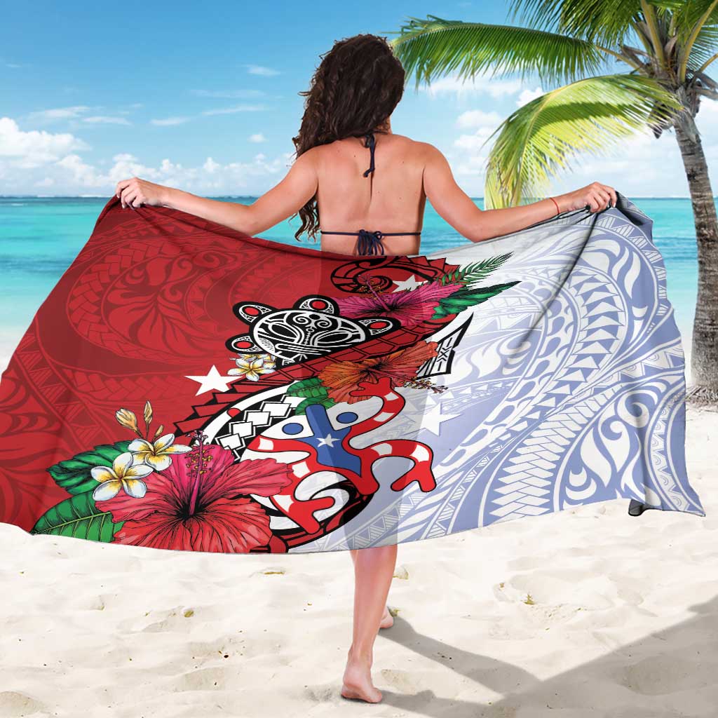 Tribal print sarong draped around the body, red and light-blue with floral and turtle art