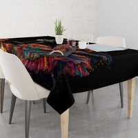 Black Dia de los Muertos tablecloth, colorful figures and ribbons across the tabletop