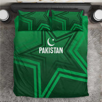 Green bedding set showing Pakistan logo, crescent star, and bold geometric pattern on duvet