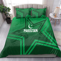 Green bedding set with Pakistan logo, crescent star, and geometric stripe pattern