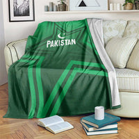 Green Pakistan sports blanket covering bed, star-and-crescent and PAKISTAN text
