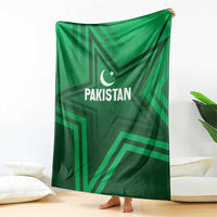 Green Pakistan sports blanket with star-and-crescent emblem, draped over couch