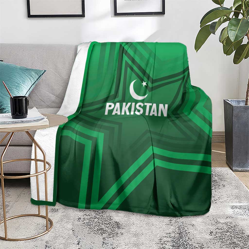 Green Pakistan sports blanket on living-room rug, star-and-crescent emblem and stripes