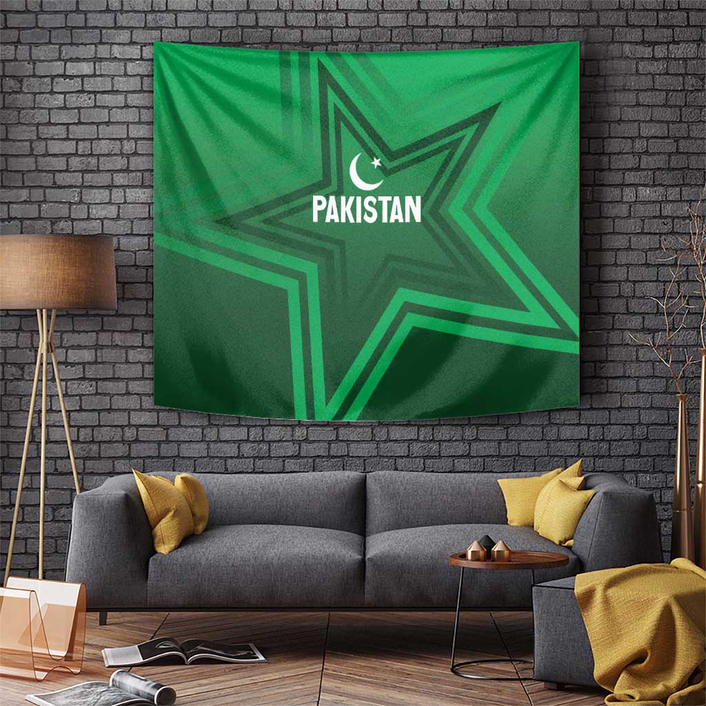 Green Pakistan star tapestry on brick wall with crescent moon and "PAKISTAN" text.