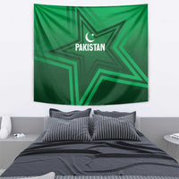 Green Pakistan star tapestry above bed, with crescent and "PAKISTAN" text centered.