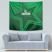 Green Pakistan star tapestry hanging on wall, showing crescent and "PAKISTAN" text.
