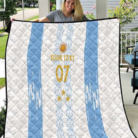 White and light-blue quilt with diagonal stripes, crest, stars, and large “07” emblem.