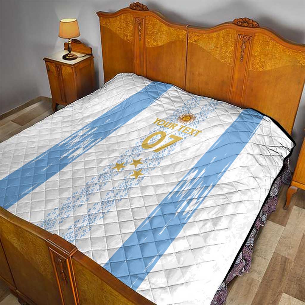 Bed quilt in white with light-blue diagonal banding, crest and stars, “YOUR TEXT 07”.