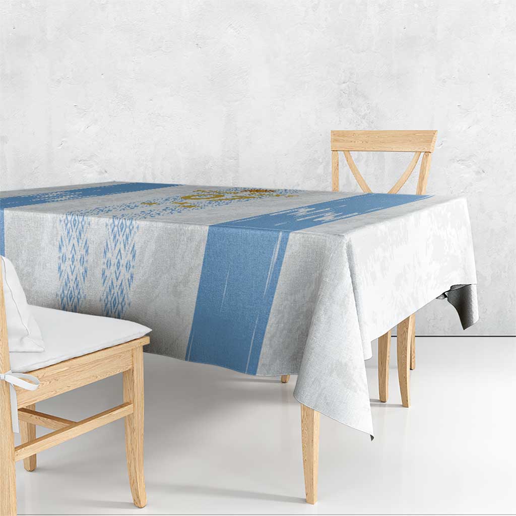 Blue-and-white custom tablecloth draped over rectangular table with geometric center stripe