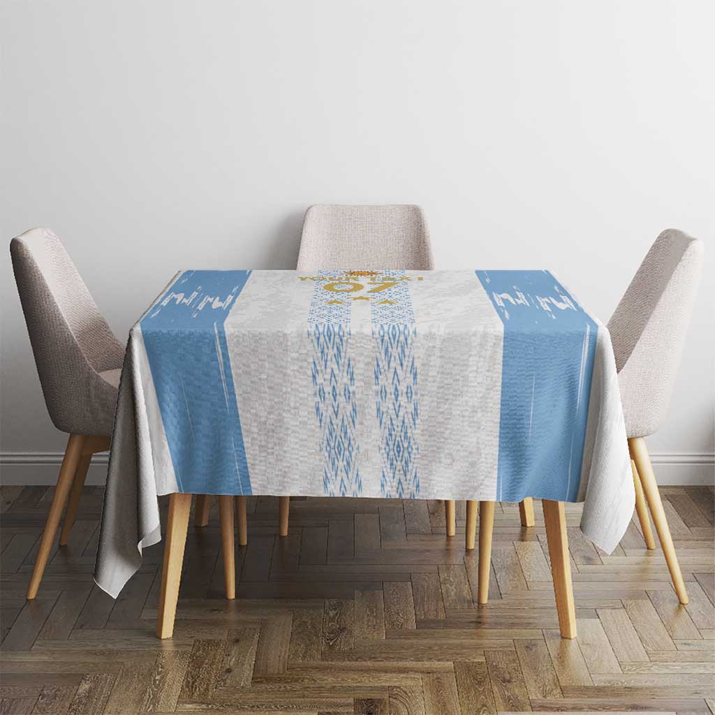 Blue-and-white custom football tablecloth on round dining table with emblem and side panels