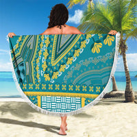 Teal dashiki beach blanket with yellow print and white fringe, held out as wrap