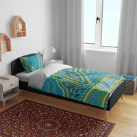 Teal dashiki duvet cover set with two pillow shams, geometric yellow accents on bed