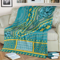 Teal ornamental blanket with yellow accents, geometric lines, and decorative band border