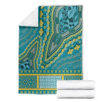 Teal dashiki blanket folded display with yellow motifs and matching patterned border