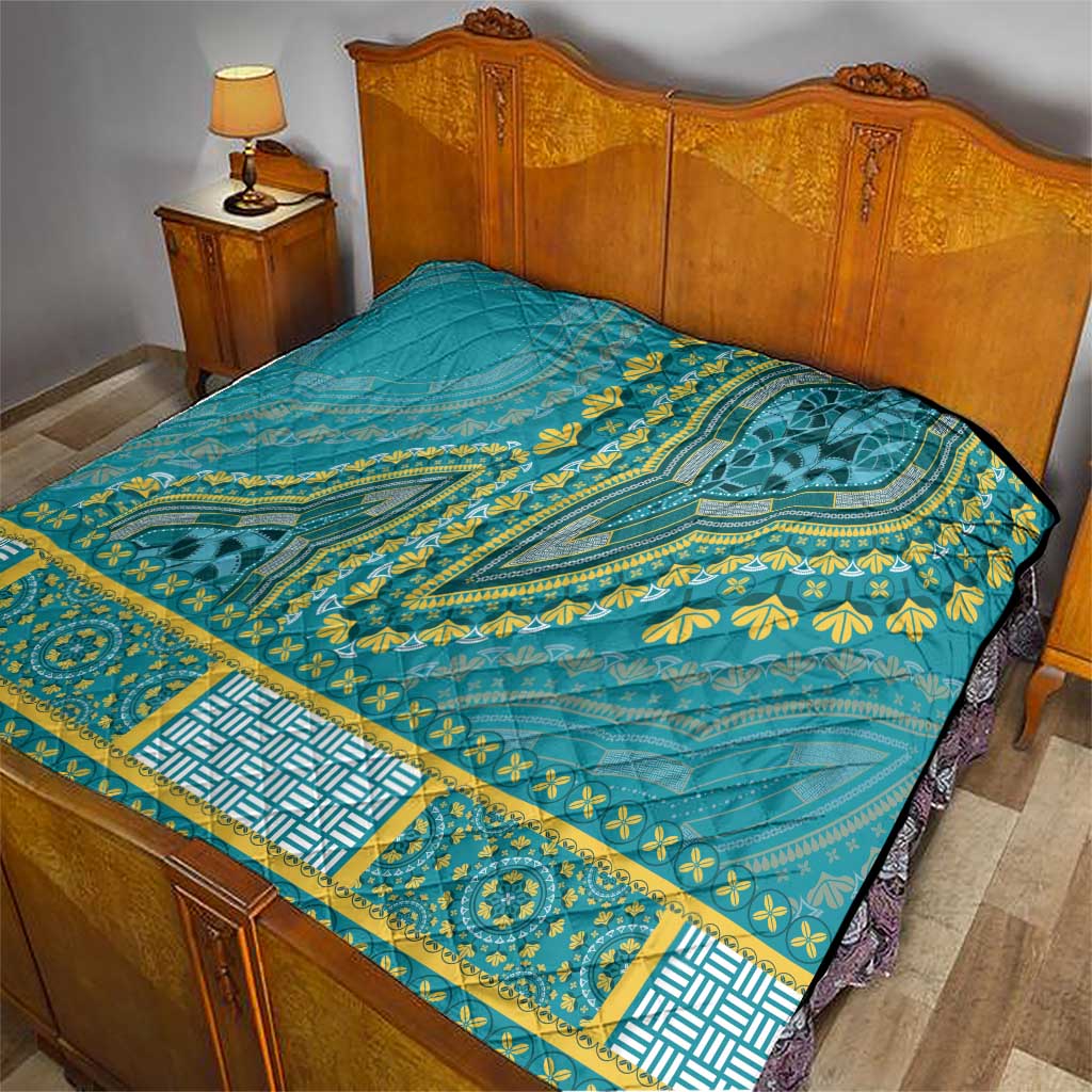 Teal dashiki-style quilt on bed with yellow geometric border and quilted texture