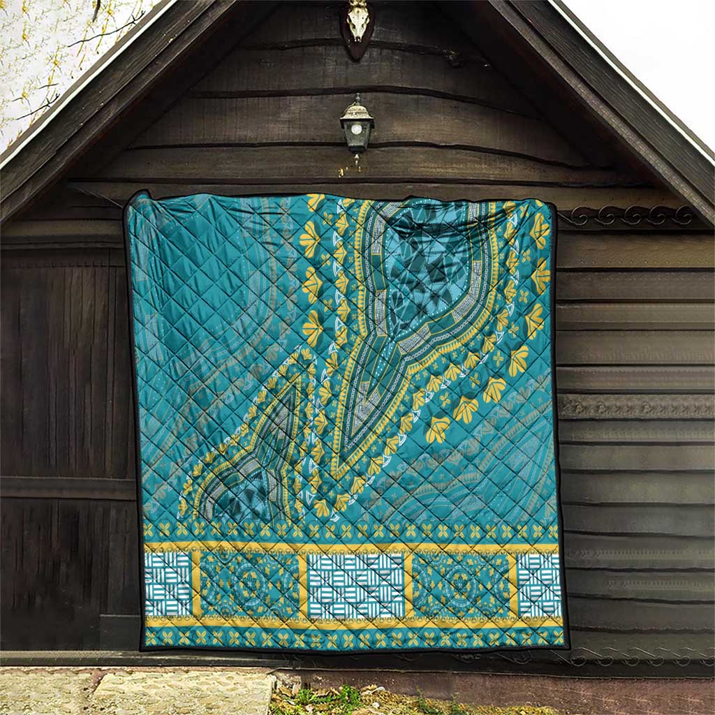 Teal dashiki-style quilt hung on wall with yellow medallion and geometric border