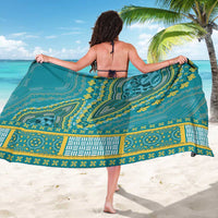 Teal dashiki sarong with bold medallion motifs and decorative border, held open